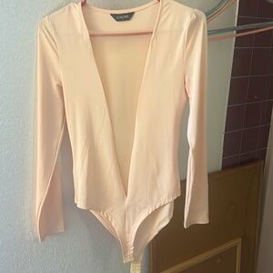 Bodysuit, silk with sheer see thru v in front. Very sexy and classy.